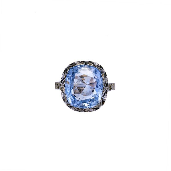 Ring with diamonds and light blue sapphire