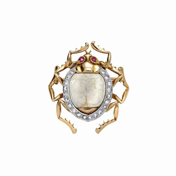 Gold brooch in white, yellow gold, bone, rubies and diamonds