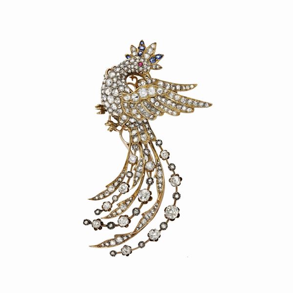 Brooch in yellow gold, sapphires, rubies and diamonds
