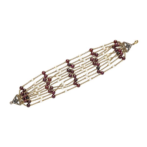 Bracelet in yellow gold, low title gold, silver, cultivated pearls and garnets