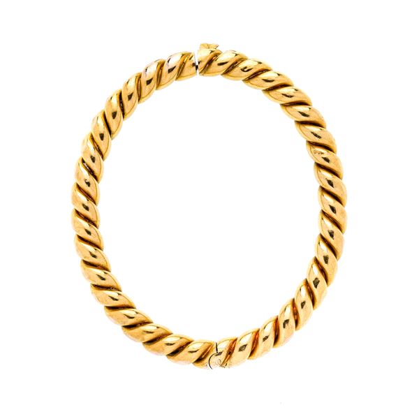 Rigid bracelet torchionne in yellow gold