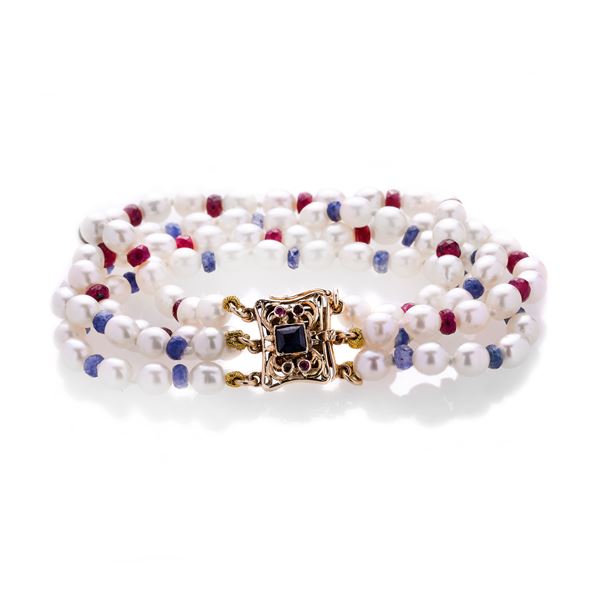 Bracelet in cultured pearls, sapphires, rubies with firmness in yellow gold
