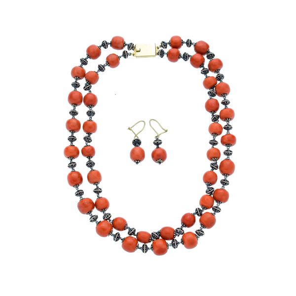 Set in silver, yellow gold and red coral