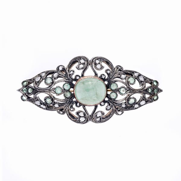 Brooch in low gold, silver and emeralds