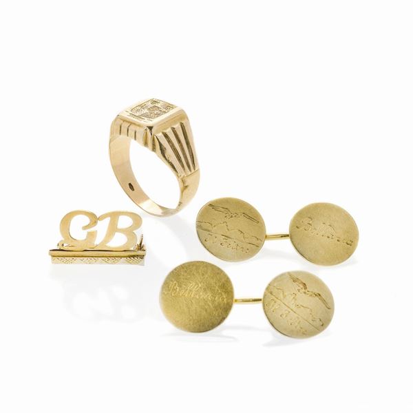 Lotto con paio di gemelli, anello chevalier e spilla in oro giallo