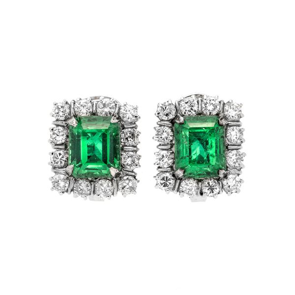 Pair of clip earrings in white gold, diamonds and emerald doublets