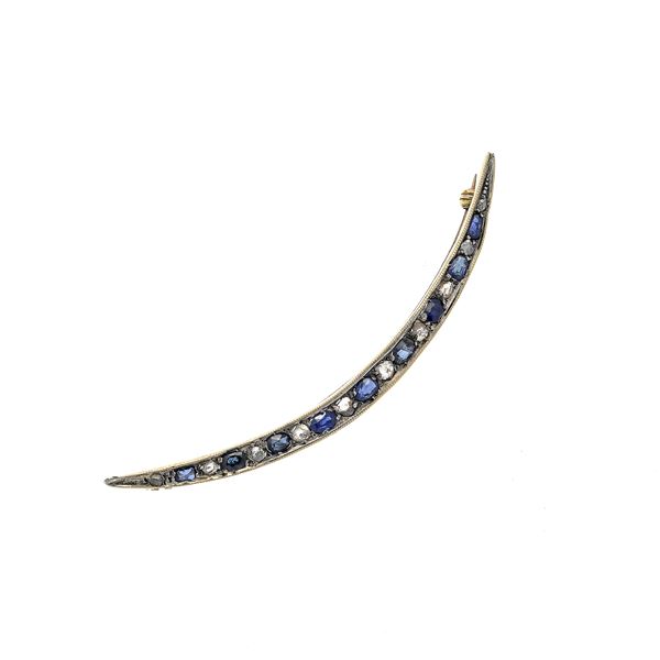 Half moon gold brooch with low title, silver, diamonds and sapphires