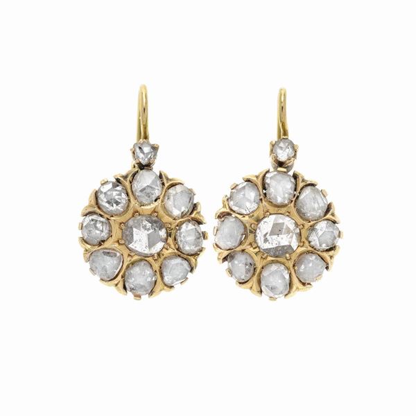 Pair of a fish hook earrings in yellow gold and diamonds