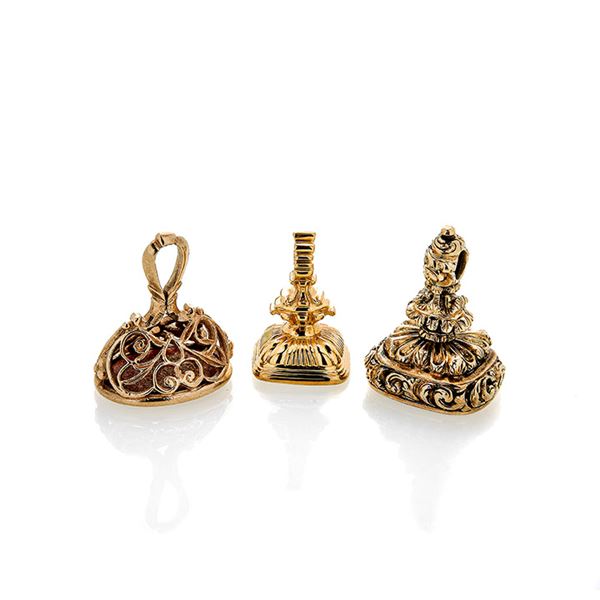 Three seals in low title gold, hard stone and carnelian engraved