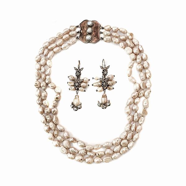 Set in low-titled gold, scaramazza pearls and diamonds