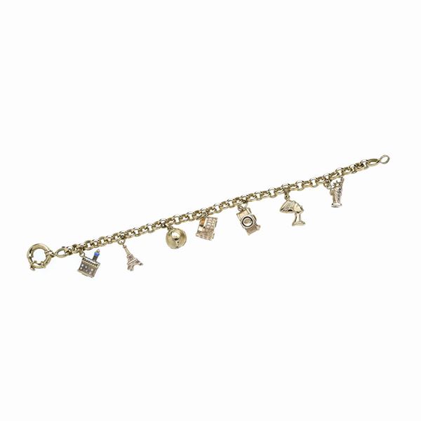 Bracciale in oro giallo  con charms "ricordi di viaggio"  (Anni Ottanta)  - Asta Asta di Gioielli Antichi, Moderni e Orologi - Curio - Casa d'aste in Firenze