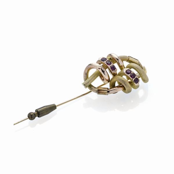 Low title gold brooch and red stones
