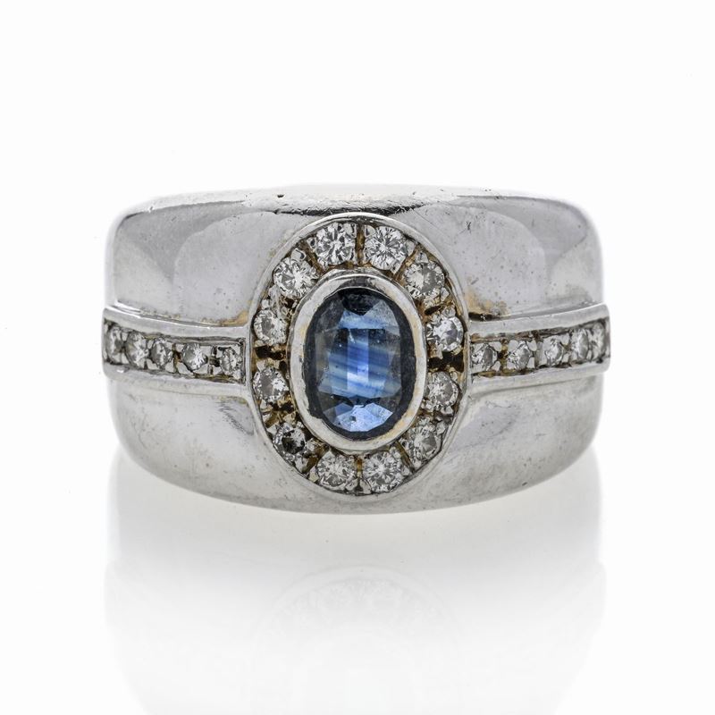 Anello a fascia in oro bianco 18 kt, diamanti e zaffiro