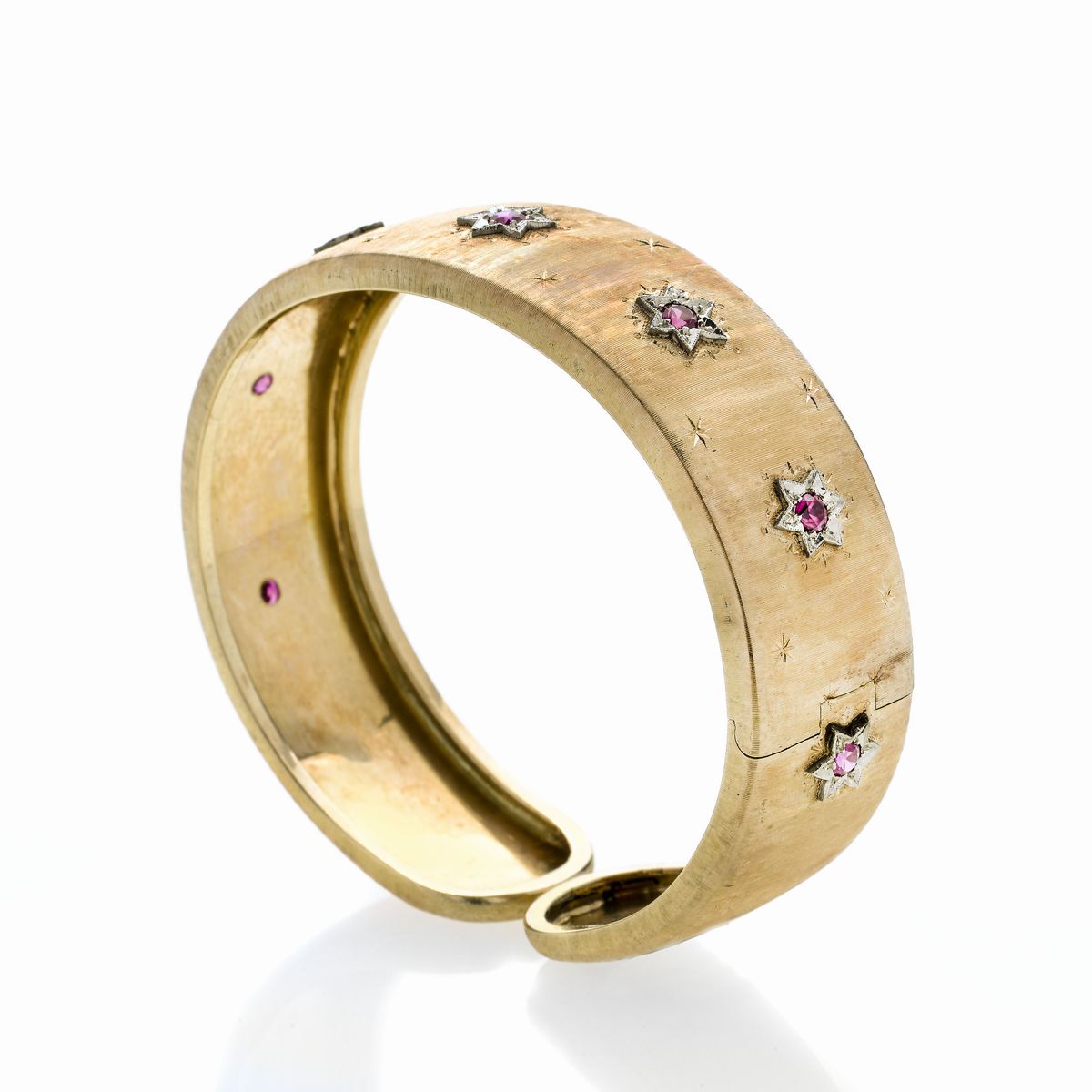 Bracciale rigido in oro giallo, oro bianco e pietre rosse