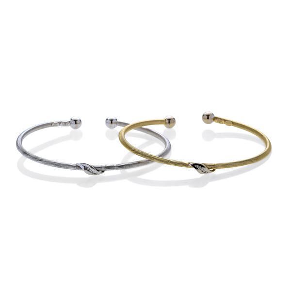 Pair of rigid bracelets in yellow gold, white gold and diamonds
