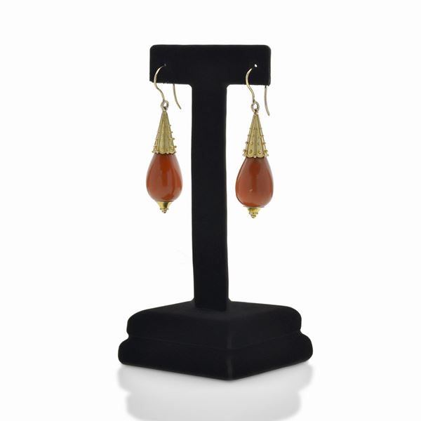 Pair of pendant earrings in yellow gold and pink coral