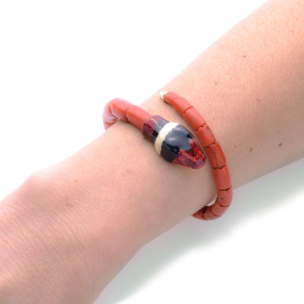 Snake bracelet in red coral, yellow gold and colored enamels