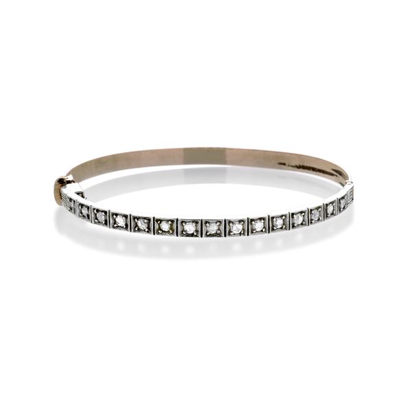 Rigid bracelet in low title gold and diamonds