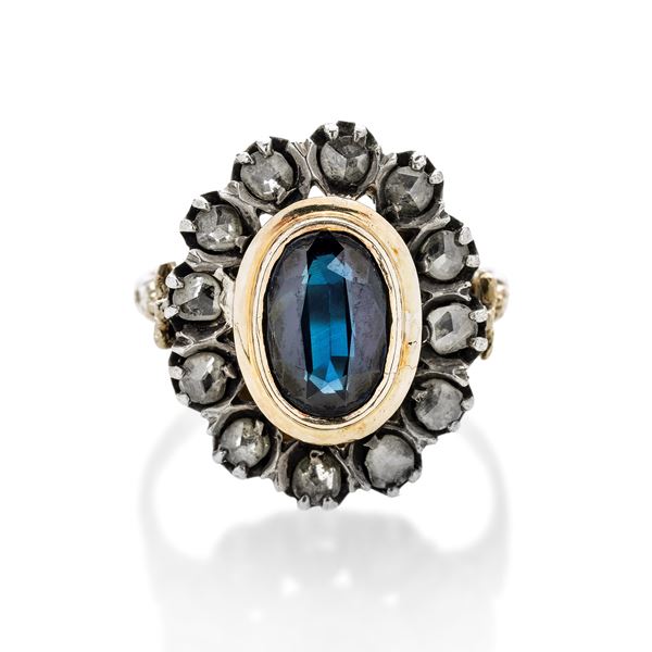 Ring in yellow gold, silver, diamonds and sapphire