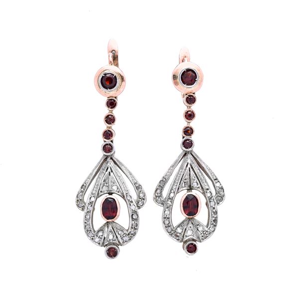 Pair of dangling earring in low title gold, silver, garnets and diamonds