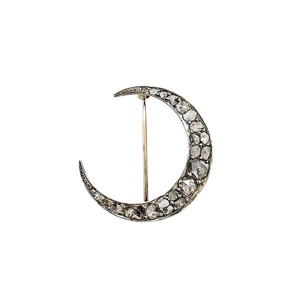 Half-moon brooch in low title gold, silver and diamonds