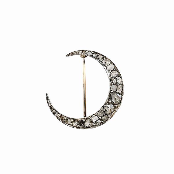 Half-moon brooch in low title gold, silver and diamonds