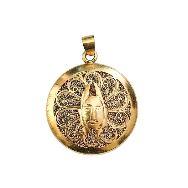 African pendant in low title gold