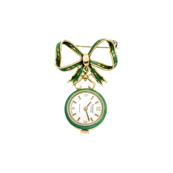 Brooch watch in yellow gold and green emanel