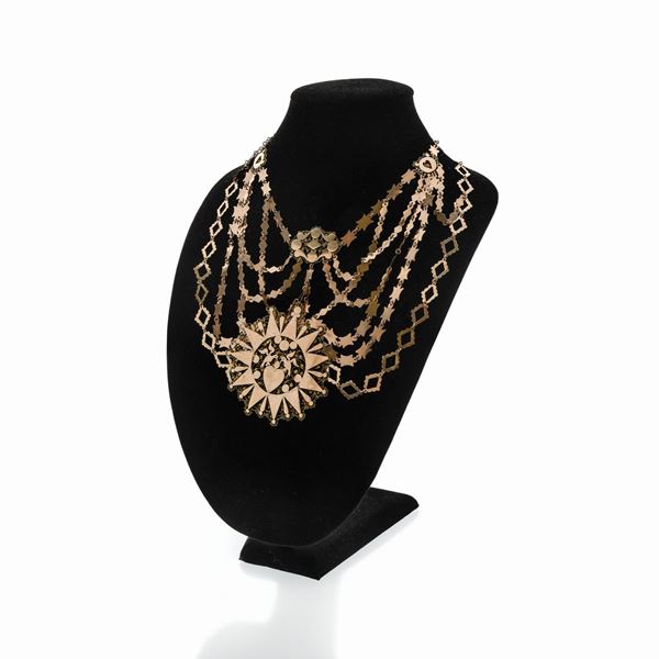 Large necklace in low title gold and red stone