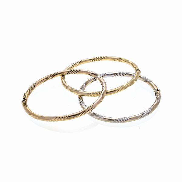 Three different colored gold bracelets