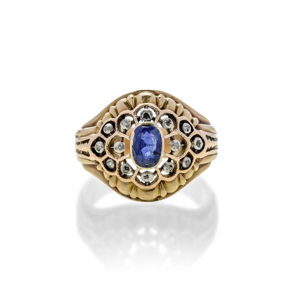 Domed ring in low title gold, silver, diamonds and sapphire
