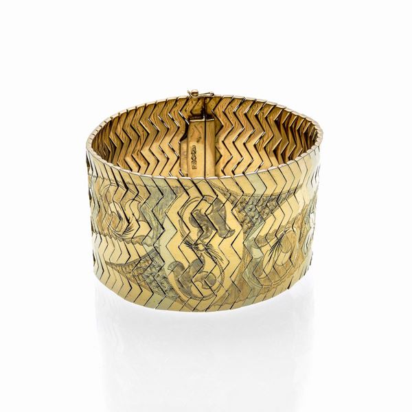 Alto bracciale in oro giallo e oro bianco