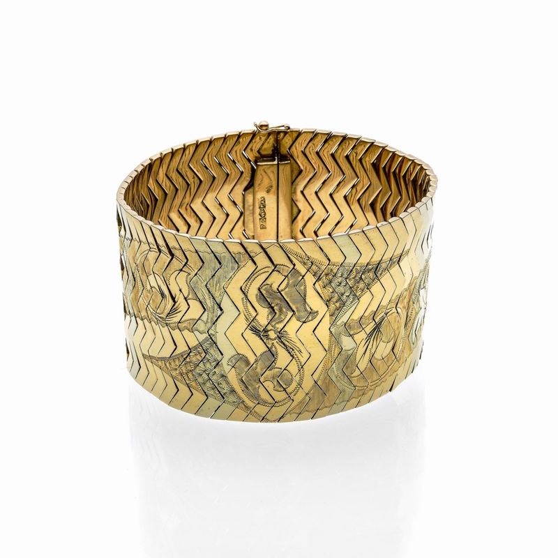 Alto bracciale in oro giallo e oro bianco