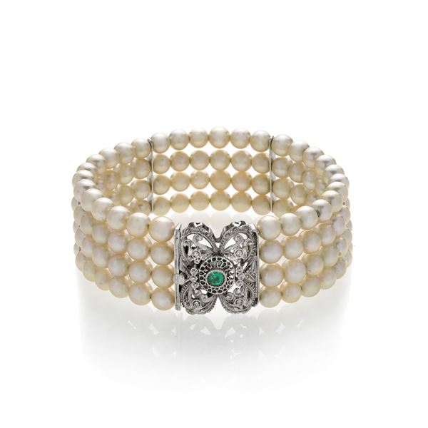 Rigid bracelet in pearls, white gold, diamonds and emerald
