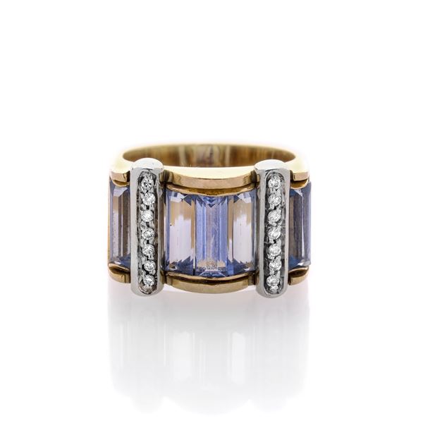 Bridge ring in 18 kt yellow gold and white gold, diamonds and topazes