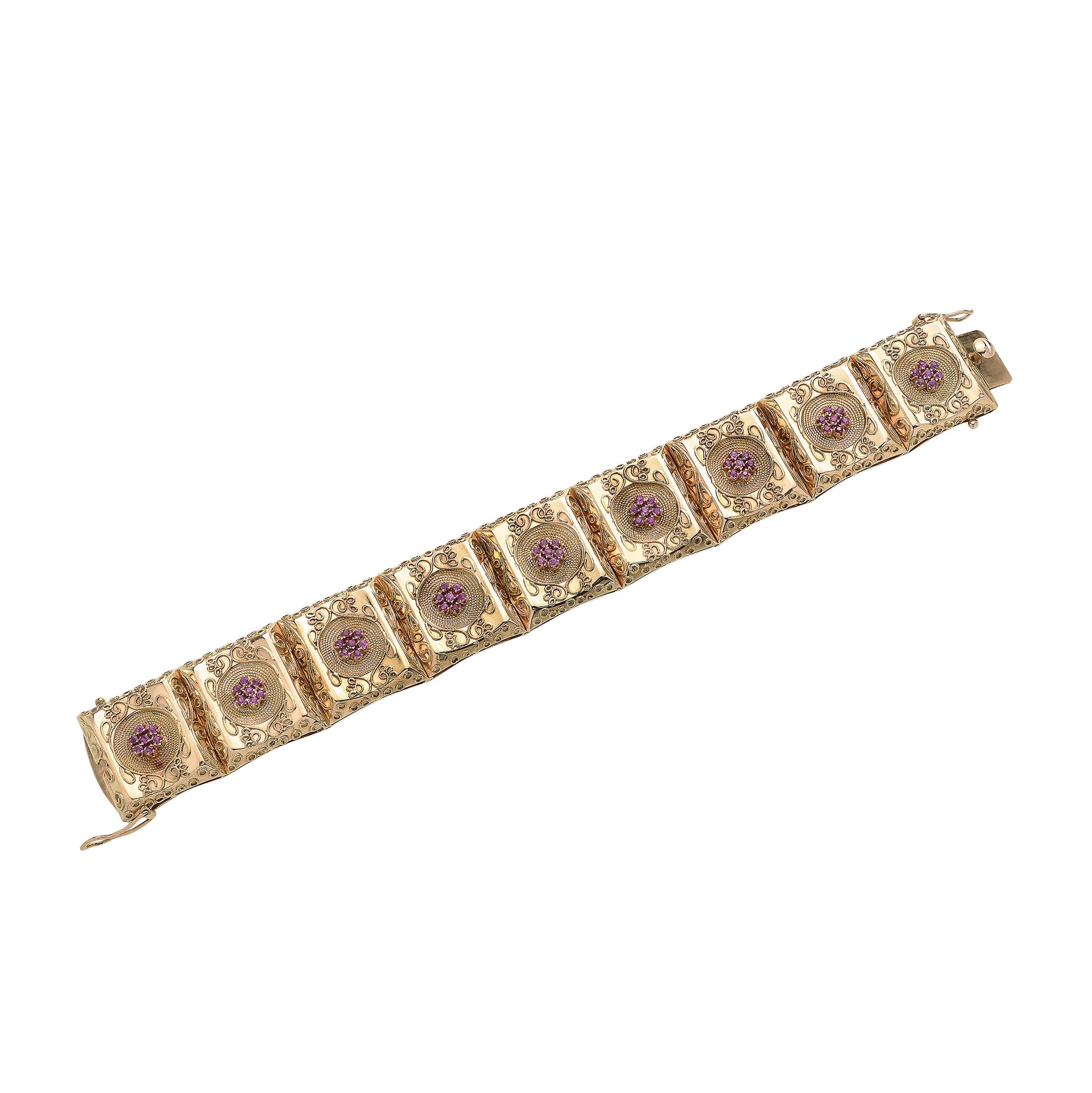 Alto bracciale in oro giallo e rubini