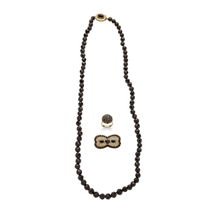 Collana, spilla rettangolare e anello in oro giallo 18 kt e granati