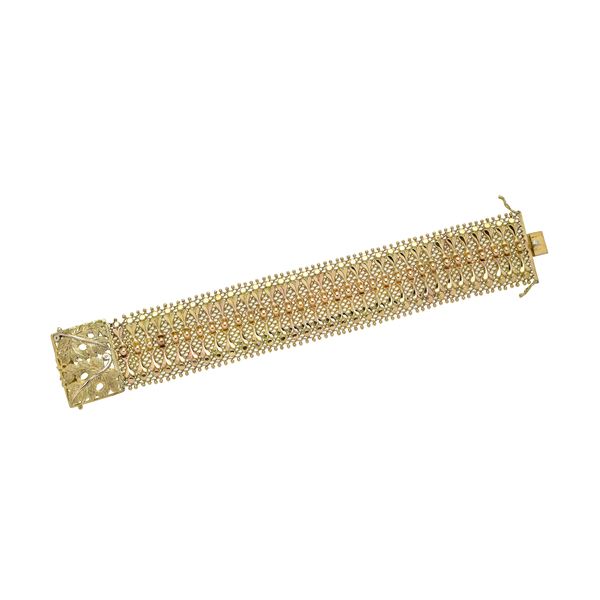 Alto bracciale in oro giallo