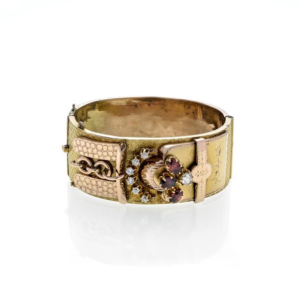 Rigid bracelet in low title gold, garnets and diamonds