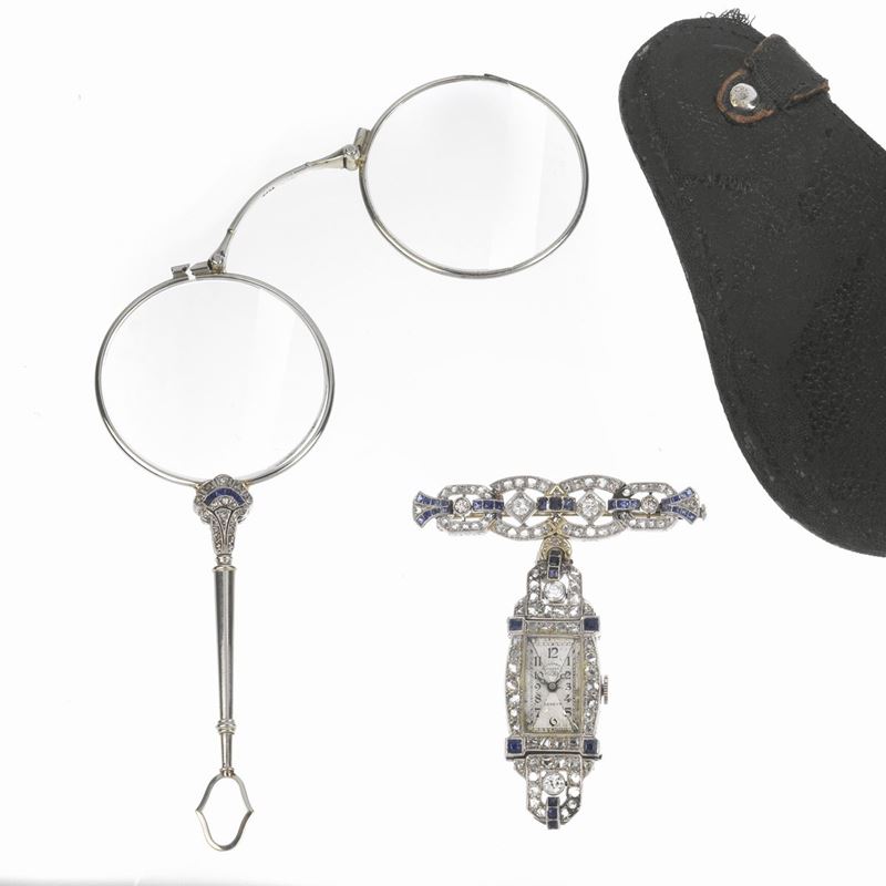 Spilla orologio in oro bianco 18 kt diamanti e zaffiri ed una lorgnette in platino en suite