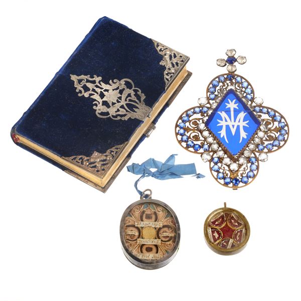 Two oval silver reliquaries, prayer book and bronze and rhinestone finial