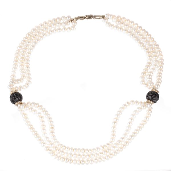 Three-strand necklace in faceted pearls, white gold, diamonds and engraved wooden spheres