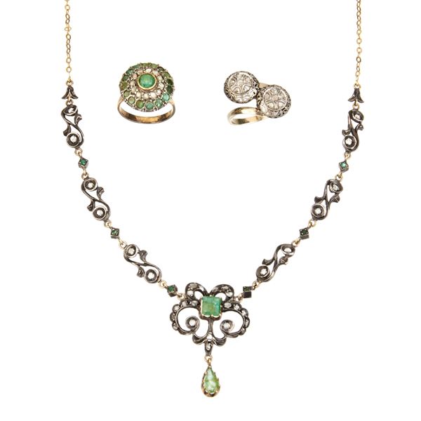 Set in 18 kt gold, low title gold, silver, diamonds and emeralds