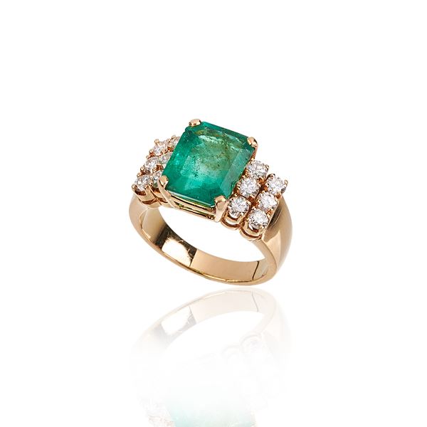 Band ring in 18 kt yellow gold, diamonds and emerald