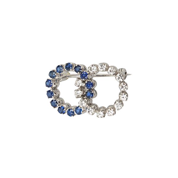 Double circle brooch in white gold, diamonds and sapphires