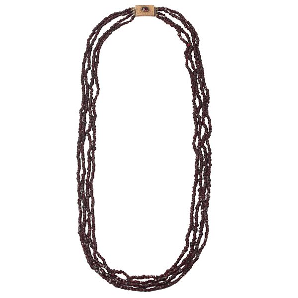 Four strand garnet necklace with low title gold and garnet fastening