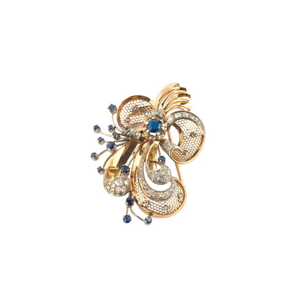 Large clip in 18 kt yellow and white gold, diamonds and sapphires