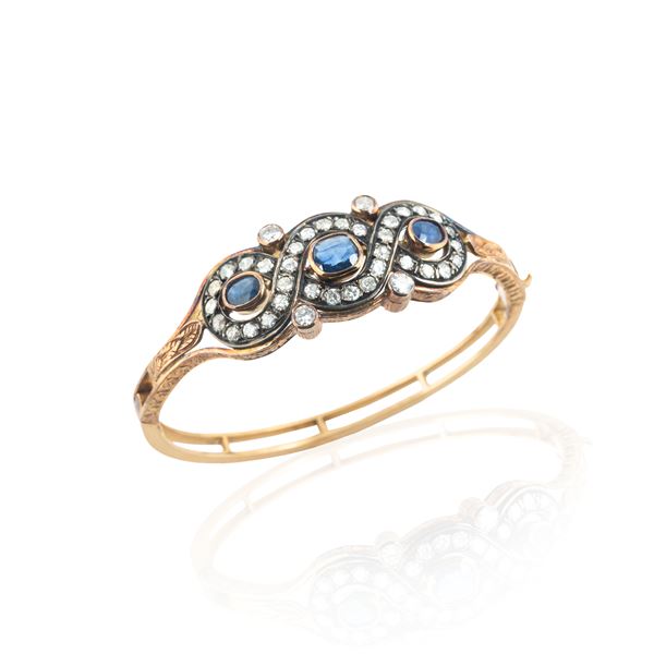 Rigid bracelet in 18 kt yellow gold, silver, diamonds and sapphires