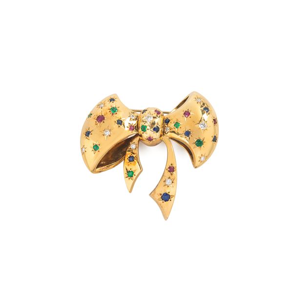 Bow brooch in 18 kt yellow gold, diamonds, sapphires, emeralds and rubies